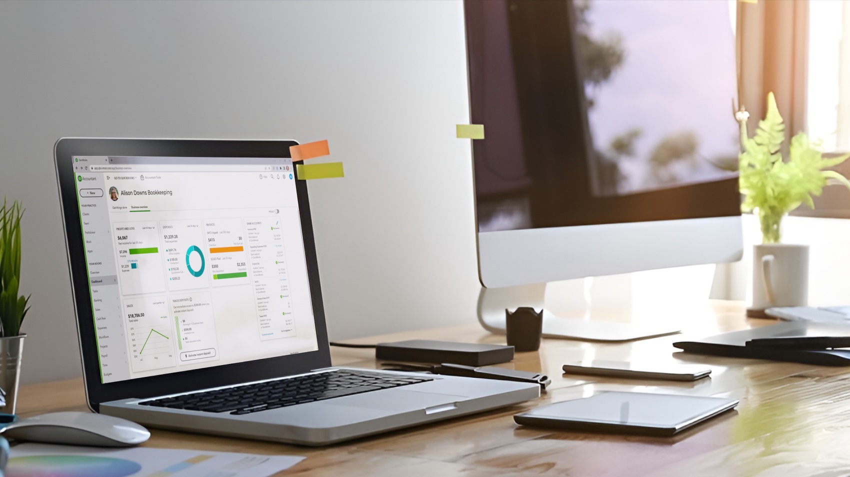 An image of a computer on a glass table with Alison's Quickbooks bookkeeping page displayed